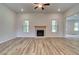Open-concept living room featuring hardwood floors and a brick fireplace at 31 Homesite Cooper E Cv, Fayetteville, GA 30214