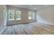 Open living room with hardwood floors and large windows at 31 Homesite Cooper E Cv, Fayetteville, GA 30214