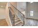 Beautiful staircase with wooden steps and iron railings, bathed in natural light from the adjacent windows at 31 Homesite Cooper E Cv, Fayetteville, GA 30214