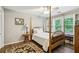 Bedroom featuring hardwood floors, a four-poster bed, and a window bench at 2819 Saddlebrook Nw Way, Marietta, GA 30064