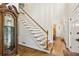 Elegant foyer features hardwood floors, staircase with white railings, and a classic grandfather clock at 2819 Saddlebrook Nw Way, Marietta, GA 30064