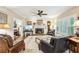 Spacious living room with a fireplace, hardwood floors, and a ceiling fan, ideal for Gathering gatherings at 2819 Saddlebrook Nw Way, Marietta, GA 30064