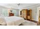 Bright main bedroom with tray ceilings, hardwood floors, and a wooden wardrobe at 2819 Saddlebrook Nw Way, Marietta, GA 30064
