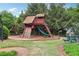 Community playground area featuring a wooden playset, swings, and benches at 2819 Saddlebrook Nw Way, Marietta, GA 30064