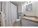 Bright bathroom featuring a shower with curtain and single sink vanity at 3594 Vinyard Way, Lawrenceville, GA 30044