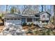 Charming blue two-story home with an attached garage, landscaped yard, and inviting entrance at 3594 Vinyard Way, Lawrenceville, GA 30044