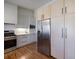 Modern kitchen boasts stainless steel appliances, sleek white countertops, and light wood cabinets at 3594 Vinyard Way, Lawrenceville, GA 30044