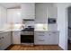 Bright kitchen featuring white cabinetry, stainless steel appliances, and wood flooring at 3594 Vinyard Way, Lawrenceville, GA 30044