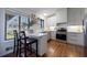 Well-lit kitchen with white cabinets, stainless steel appliances, and a breakfast bar at 3594 Vinyard Way, Lawrenceville, GA 30044
