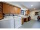 Well-equipped laundry room with washer, dryer, ample cabinetry, and a functional workspace at 3594 Vinyard Way, Lawrenceville, GA 30044