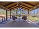 Charming screened porch features a cozy seating area and picturesque backyard views at 3594 Vinyard Way, Lawrenceville, GA 30044
