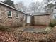 Cozy backyard with a brick home, featuring a patio area and simple landscaping, creating a private outdoor retreat at 676 Bralorne Dr, Stone Mountain, GA 30087