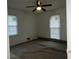 Bedroom with two windows and a ceiling fan at 676 Bralorne Dr, Stone Mountain, GA 30087