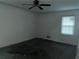 View of empty bedroom featuring a ceiling fan, a window and renovation in progress at 676 Bralorne Dr, Stone Mountain, GA 30087