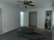 Spacious bedroom with a ceiling fan, showing open doorways and renovations in progress at 676 Bralorne Dr, Stone Mountain, GA 30087