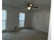 Bright bedroom with a ceiling fan and two windows at 676 Bralorne Dr, Stone Mountain, GA 30087