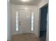 Bright entryway featuring a white front door with sidelights, creating a warm and welcoming entrance at 676 Bralorne Dr, Stone Mountain, GA 30087