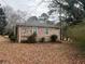 Brick home with a simple, neat exterior, set against a backdrop of trees, offering a peaceful residential setting at 676 Bralorne Dr, Stone Mountain, GA 30087