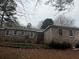 Rear brick home showcasing classic architecture and a tranquil outdoor space, perfect for relaxation at 676 Bralorne Dr, Stone Mountain, GA 30087