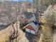 Aerial view of a home with a well-maintained roof, a two-car garage, and a landscaped yard at 7104 Big Woods Dr, Woodstock, GA 30189