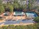 Aerial view of community recreation center with a pool, playground, tennis courts, and parking at 7104 Big Woods Dr, Woodstock, GA 30189