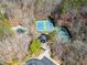 Aerial view of community tennis courts and a pool surrounded by mature trees at 7104 Big Woods Dr, Woodstock, GA 30189