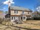 Back exterior of a two-story home with a patio and well-maintained yard at 7104 Big Woods Dr, Woodstock, GA 30189