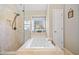 Bright bathroom featuring a soaking tub with tile surround and a glass enclosed shower at 7104 Big Woods Dr, Woodstock, GA 30189