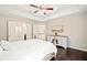 Bright bedroom with hardwood floors, tray ceiling, and a stylish dresser at 7104 Big Woods Dr, Woodstock, GA 30189