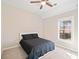 Bright bedroom featuring a modern ceiling fan, plush carpet and a large window at 7104 Big Woods Dr, Woodstock, GA 30189