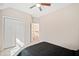 Bedroom featuring a ceiling fan, closet, and plush carpet at 7104 Big Woods Dr, Woodstock, GA 30189