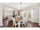 Bright dining area with wood floors and natural light, connected to the living room at 7104 Big Woods Dr, Woodstock, GA 30189