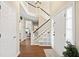 Bright foyer showcasing a staircase, wood flooring, and an open view into the living spaces at 7104 Big Woods Dr, Woodstock, GA 30189