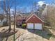 Front exterior of a brick two-story home with attached two-car garage and landscaped yard at 7104 Big Woods Dr, Woodstock, GA 30189