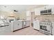 Modern kitchen featuring stainless steel appliances, a center island, and view into the living room at 7104 Big Woods Dr, Woodstock, GA 30189
