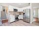 Updated kitchen with white cabinets, stainless steel appliances, and stylish backsplash at 7104 Big Woods Dr, Woodstock, GA 30189