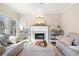 Comfortable living room featuring a fireplace with brick surround and decorative mantel at 7104 Big Woods Dr, Woodstock, GA 30189