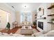 Comfortable living room featuring a fireplace, wood floors, and a bay window with natural light at 7104 Big Woods Dr, Woodstock, GA 30189