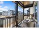 A cozy balcony with wicker seating, a small accent table, and neighborhood views at 1053 Knoxboro Ln, Woodstock, GA 30188