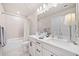 Bright bathroom featuring a large vanity, double sinks, and a shower-tub combo at 1053 Knoxboro Ln, Woodstock, GA 30188