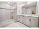 Bathroom featuring double vanity, glass shower, and neutral tones at 1053 Knoxboro Ln, Woodstock, GA 30188