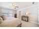 Bright bedroom with carpet, ceiling fan, large window, and neutral wall color at 1053 Knoxboro Ln, Woodstock, GA 30188