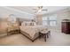 Comfortable primary bedroom with neutral tones, ceiling fan, and carpeted floor at 1053 Knoxboro Ln, Woodstock, GA 30188
