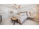 Well-lit primary bedroom featuring a ceiling fan, carpet, and large windows at 1053 Knoxboro Ln, Woodstock, GA 30188