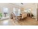 Elegant dining room with modern light fixture, hardwood floors, and natural light at 1053 Knoxboro Ln, Woodstock, GA 30188