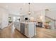 Open concept kitchen island with pendant lighting and stainless steel dishwasher at 1053 Knoxboro Ln, Woodstock, GA 30188