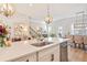Kitchen island featuring granite countertops and stainless appliances open to dining and Gathering area at 1053 Knoxboro Ln, Woodstock, GA 30188
