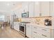 Updated kitchen with white cabinets, stainless steel appliances, and eat in dining area at 1053 Knoxboro Ln, Woodstock, GA 30188