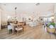 Open-concept living space with dining area, kitchen, and hardwood floors at 1053 Knoxboro Ln, Woodstock, GA 30188