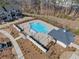 Overhead aerial shot of a pristine community pool with adjacent clubhouse surrounded by townhomes at 1053 Knoxboro Ln, Woodstock, GA 30188